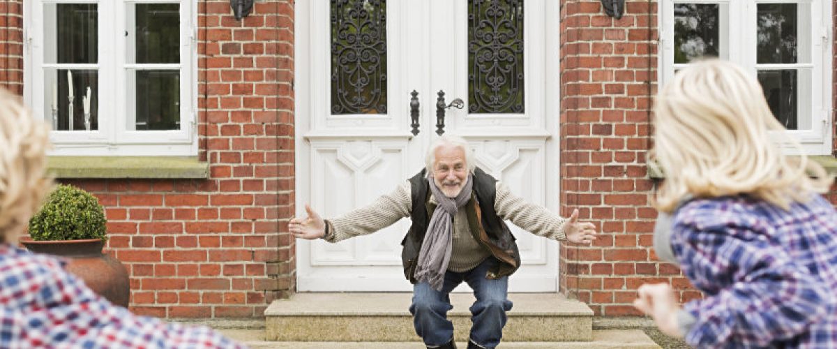 Grandfather welcoming grandchildren with arms open