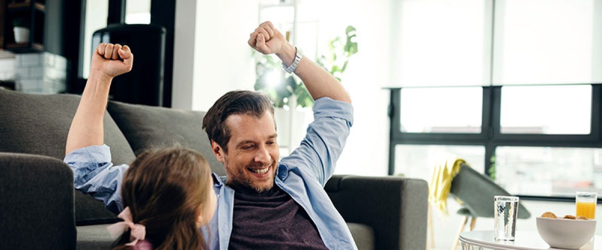 happy-father-celebrating-while-using-laptop-with-h-2024-12-13-18-07-21-utc_fet