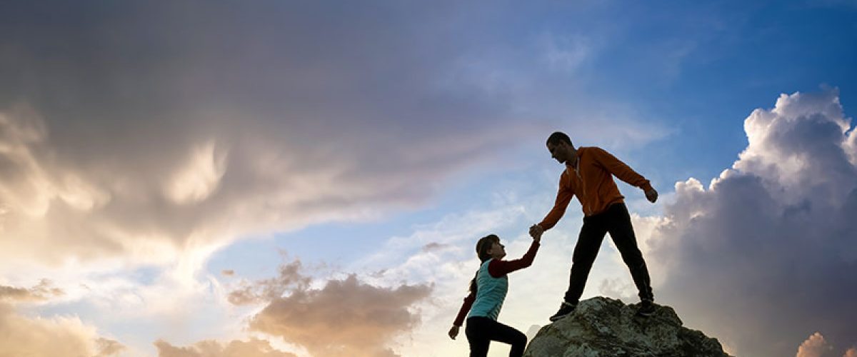 man-and-woman-hikers-helping-each-other-to-climb-a-2024-12-06-04-16-41-utc_res