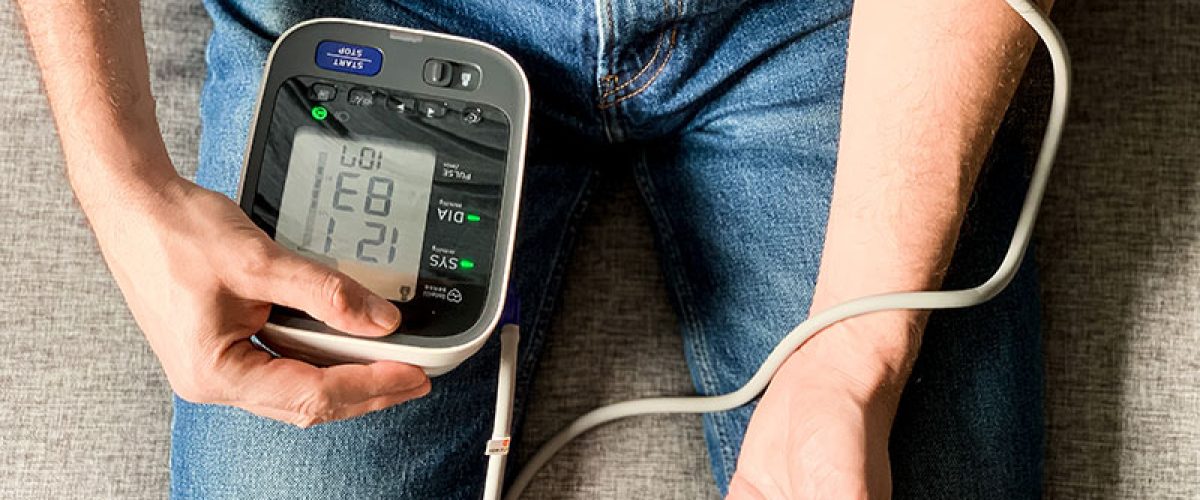 man-checking-blood-pressure-at-home-sitting-on-a-2024-12-07-19-39-26-utc_res
